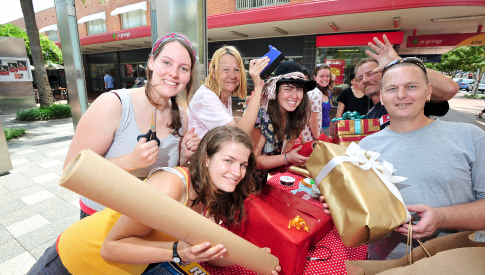Marinka Terry and Alicia Comlon get a hand from customer Margarita Rouse while fellow wrappers Melanie Boreham, Jess Young, Jeff Rouse and Michael Rochford help out. Marinka Terry and Alicia Comlon get a hand from customer Margarita Rouse while fellow wrappers Melanie Boreham, Jess Young, Jeff Rouse and Michael Rochford help out.